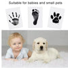 A DIY wooden photo frame kit for baby and pet paw prints featuring a small child and a white dog.