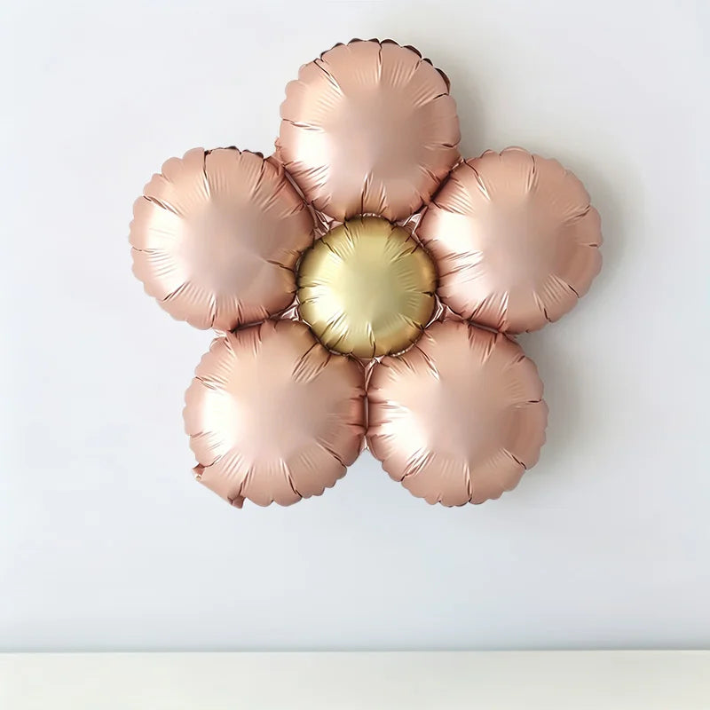 A set of five matte foil balloons in rose gold and pink with a golden center, arranged in a flower shape.