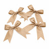 Three light beige satin ribbon bows arranged diagonally on a white background.