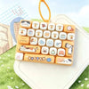 A rectangular tray of cute cartoon animal keycap fidget toys with various designs and colors resting on a white surface.