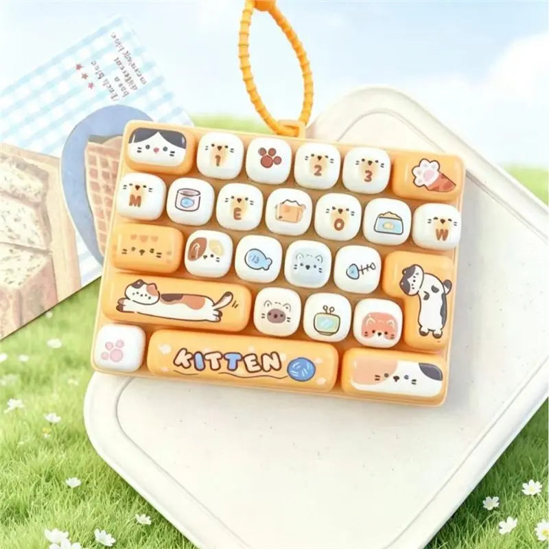A rectangular tray of cute cartoon animal keycap fidget toys with various designs and colors resting on a white surface.