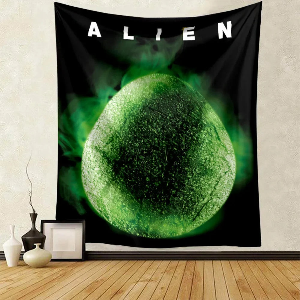A black tapestry featuring a glowing green spherical alien head against a dark background.