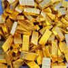 A pile of small, rectangular gold bars used as decor.