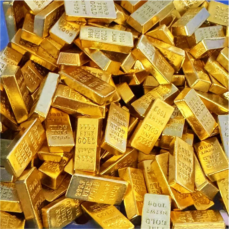 A pile of small, rectangular gold bars used as decor.