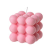 A cluster of pink soy wax candles shaped like spheres and arranged in a cube pattern.