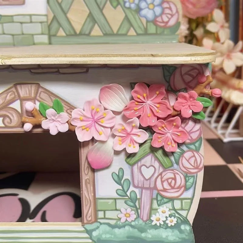 A decorative dashboard ornament featuring pink and green floral designs on a wooden base.
