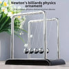 A silver Newton's physics ornament demonstrating the principle of elastic collision with balance balls.