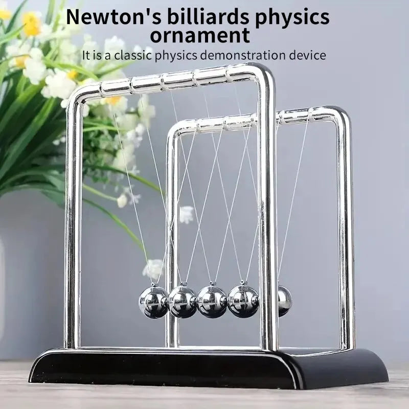 A silver Newton's physics ornament demonstrating the principle of elastic collision with balance balls.