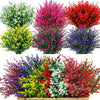 A collection of vibrant artificial lavender and flowering shrubs in various shades of pink, red, yellow, and purple.