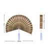 Handwoven bamboo wall fan decor featuring a pleated design and a tassel.