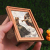 A wooden framed art print featuring a painting of a lion looking down from the sky.