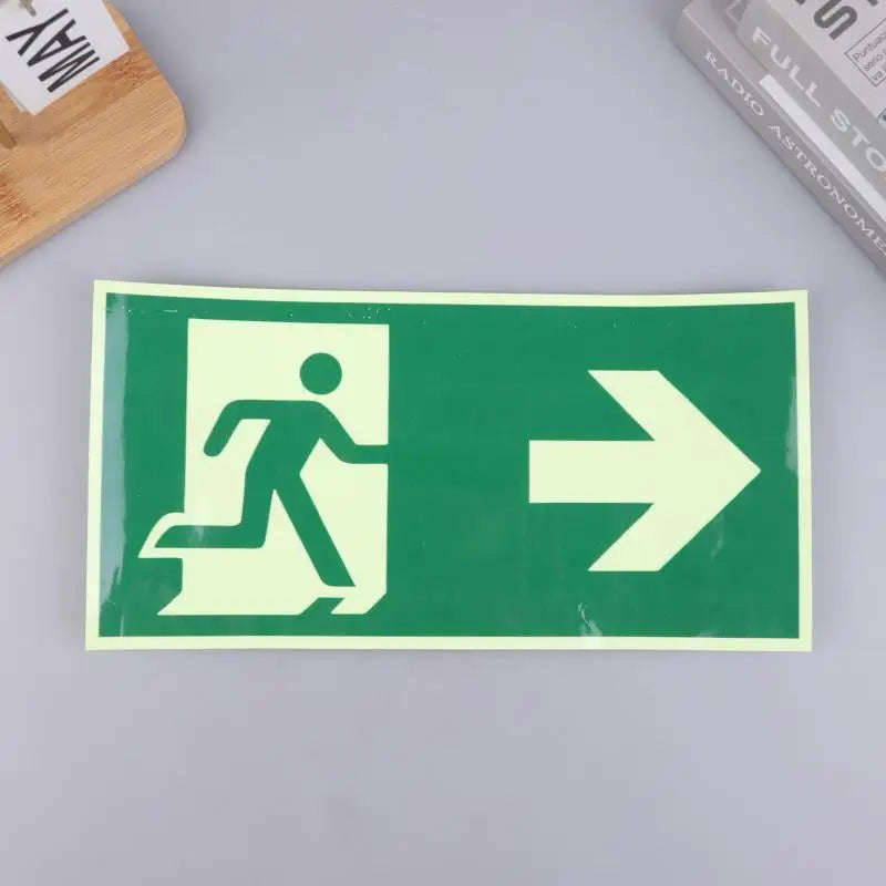 A rectangular photoluminescent emergency exit sign decal with a white figure running and an arrow pointing right on a green b