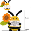 Handmade crochet bee doll with black and yellow stripes and an inspirational card