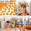 A collection of bright orange acrylic ice rocks and decorative items for Halloween party decoration