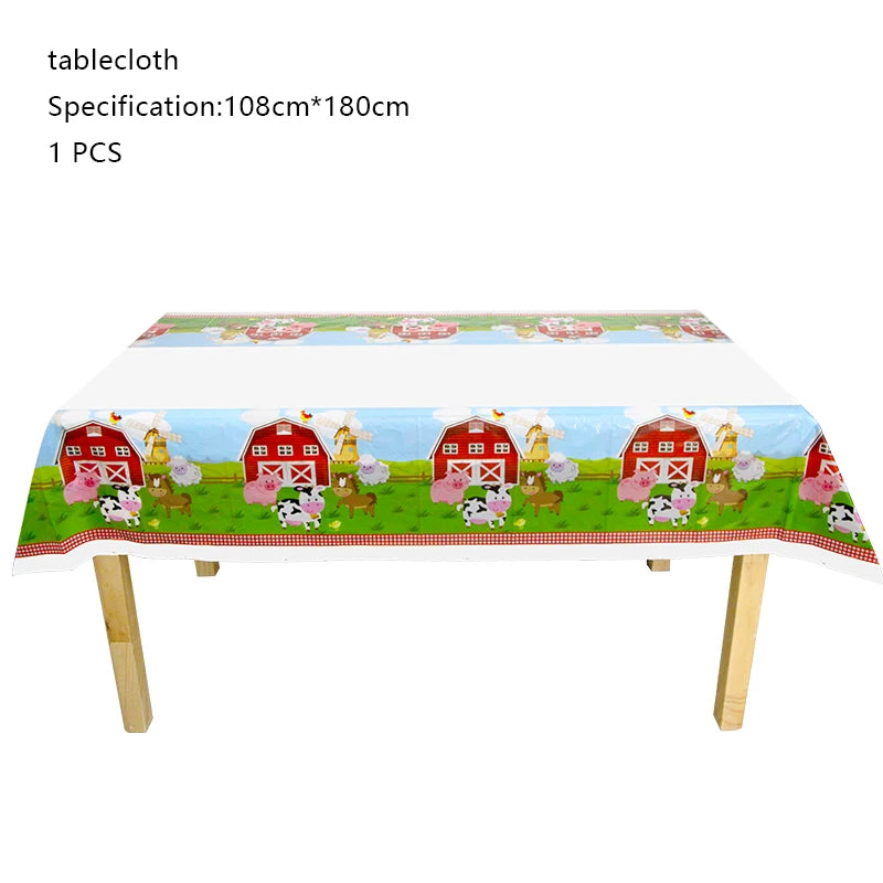 A tablecloth featuring a farm theme with red barns, animals, and flowers for a birthday party decoration.