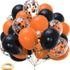 A cluster of chrome latex balloons in orange and black polka dots.