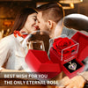 A couple shares a tender moment while a red rose is presented in an open gift box with a heart pendant necklace.