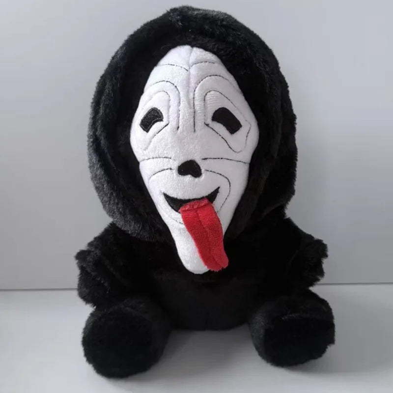 A black plush toy resembling Ghost Face with a white mask and a red tongue.