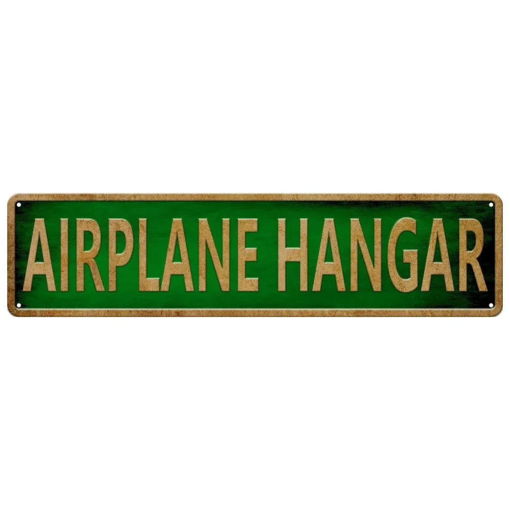 A rectangular green metal tin sign with gold lettering that reads AIRPLANE HANGAR