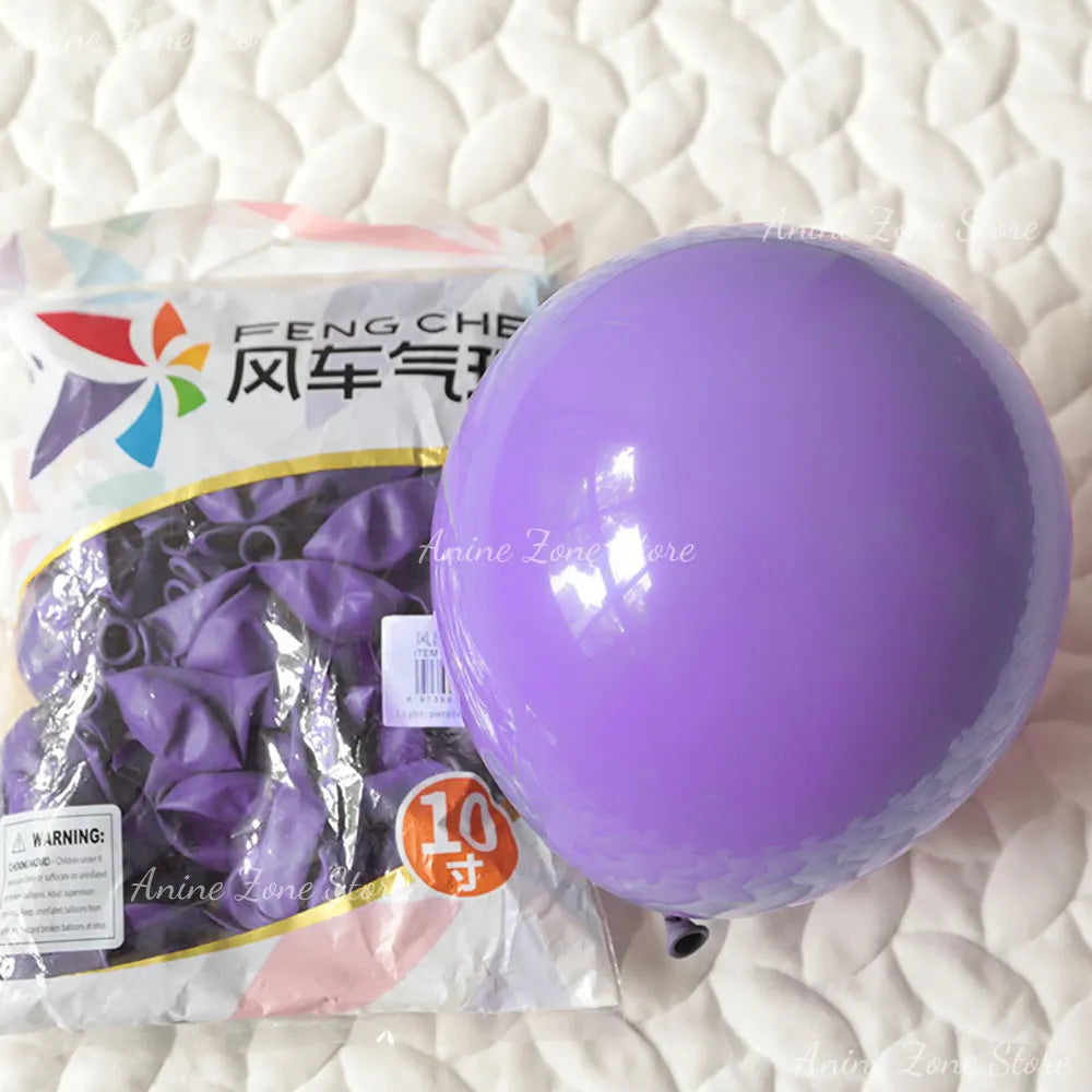 A package of purple latex balloons labeled Feng Che for party decorations next to a large purple balloon.