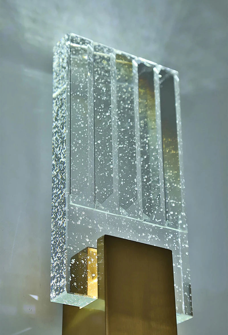 Modern bubble crystal LED wall sconces featuring clear glass panels and sparkling light.
