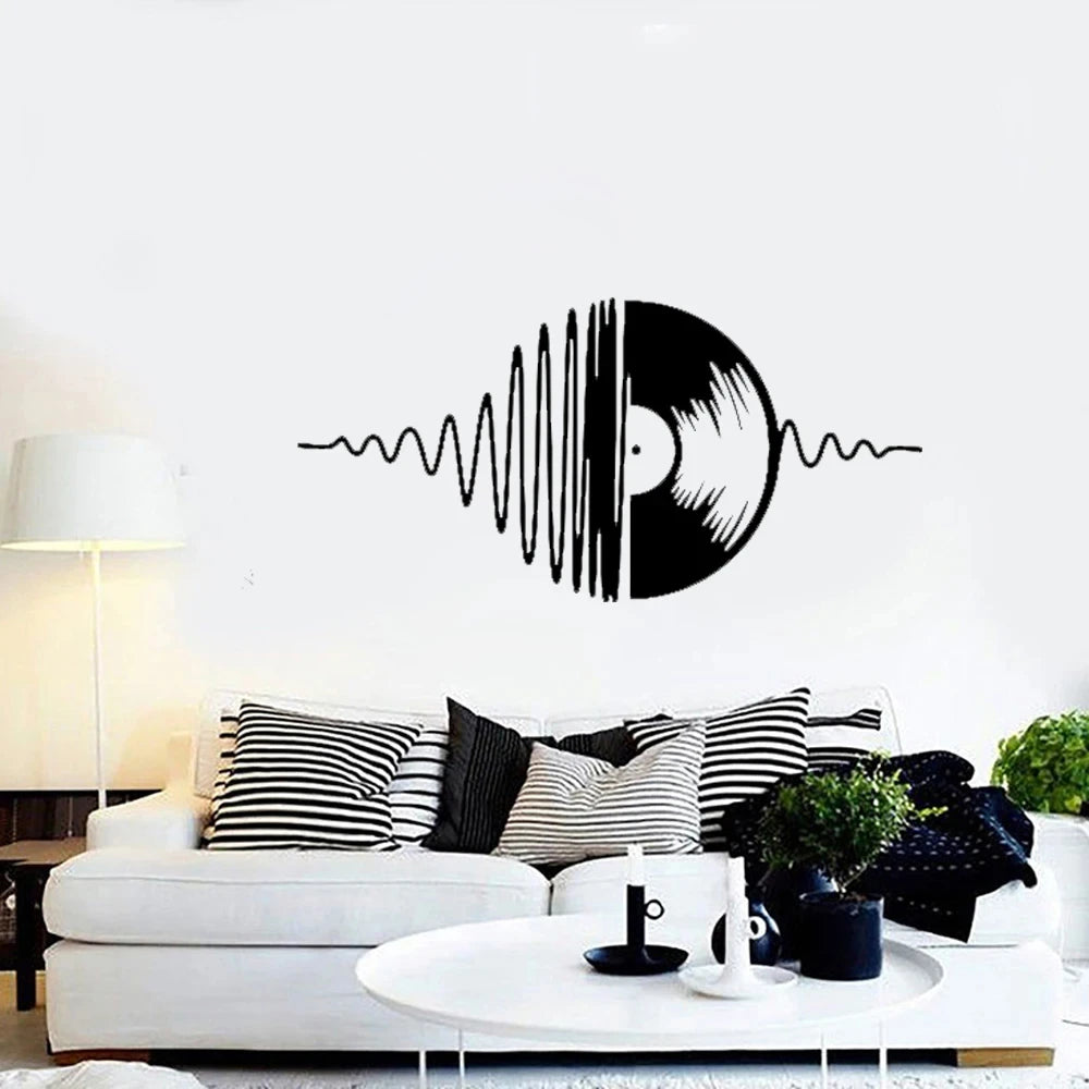 A black vinyl record sound wave graphic on a white wall above a modern sofa.