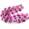 A strand of pink and purple crystal glass octagon beads used for home decor.