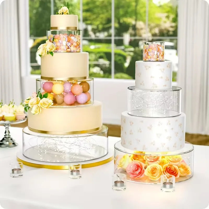 A tiered cake display featuring light pink and gold floral accents on clear acrylic stands with LED lights.