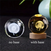 A comparison of a 3D crystal ball night light without a base and with a wooden base.