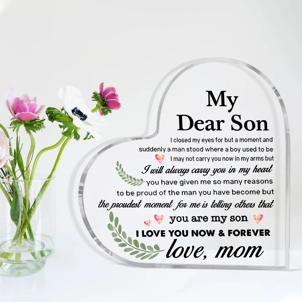 A heart-shaped acrylic keepsake plaque with engraved text 'My Dear Son' and a message of love from a mother.