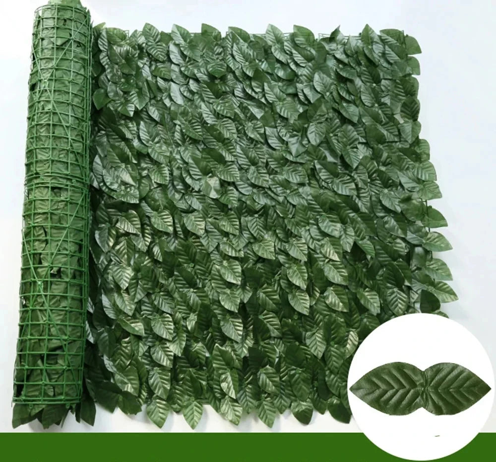 Green artificial ivy hedge fence panels rolled up and laid out, showing dense foliage.