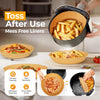 A close-up of Toss After Use mess free liners being used in a black air fryer basket filled with french fries.