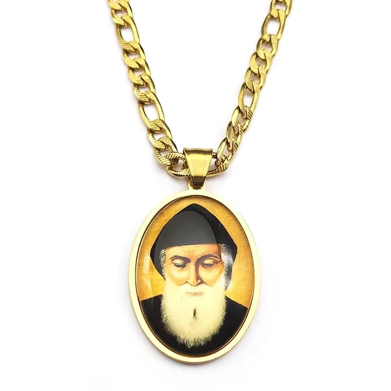 A gold-toned chain necklace with an oval pendant featuring a portrait of Saint Charbel.