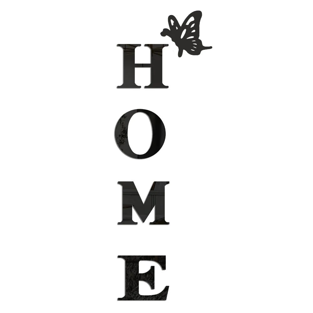 A set of four black acrylic letters spelling out HOME with a butterfly design.