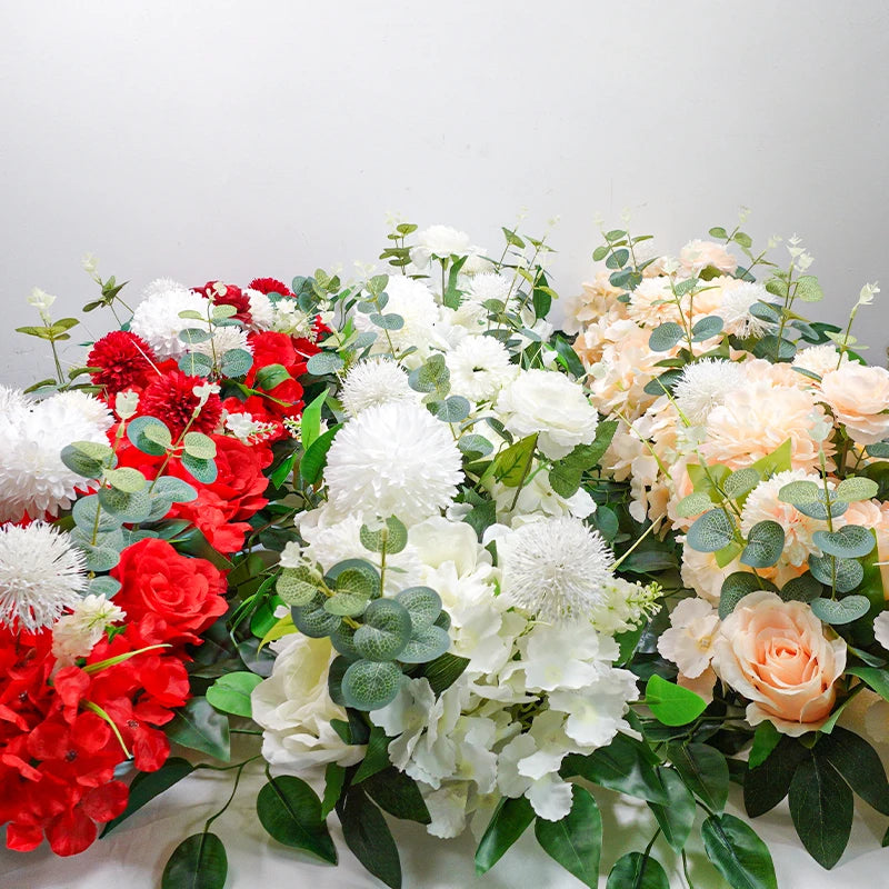 A lush arrangement of white and peach artificial roses and greenery for event decor.