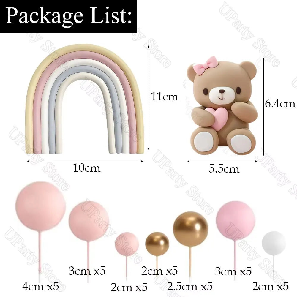 A set of boho rainbow cake toppers featuring pink ball decorations and various sized paper straws.
