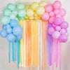 A colorful display of pastel crepe paper streamers in various shades including pink, yellow, blue, and purple.