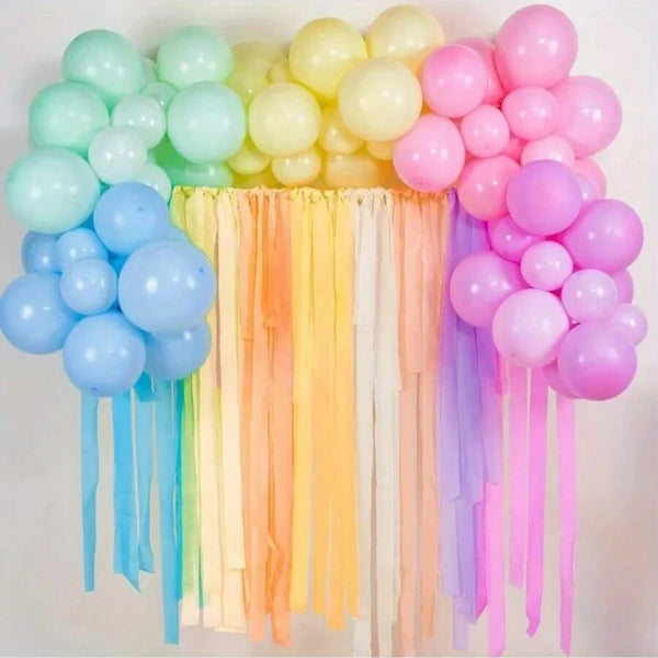 A colorful display of pastel crepe paper streamers in various shades including pink, yellow, blue, and purple.