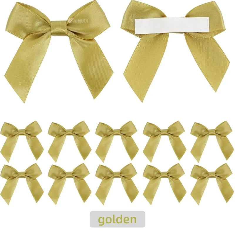 A set of golden satin ribbon bows with white adhesive backing for crafting and gift wrapping