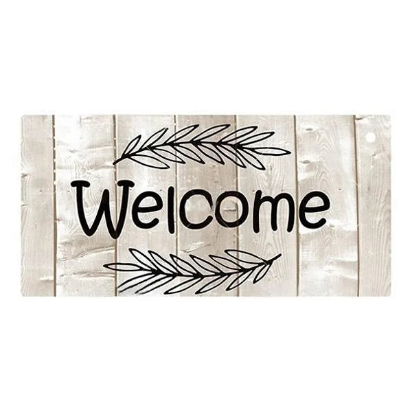A rustic wooden sign with the word Welcome written in black script surrounded by leafy branches.