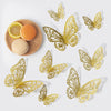 A set of gold, intricate butterfly wall decor cutouts displayed on a white background.