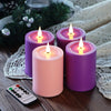 Purple and pink flameless LED candles sitting on a wooden surface next to a remote control.
