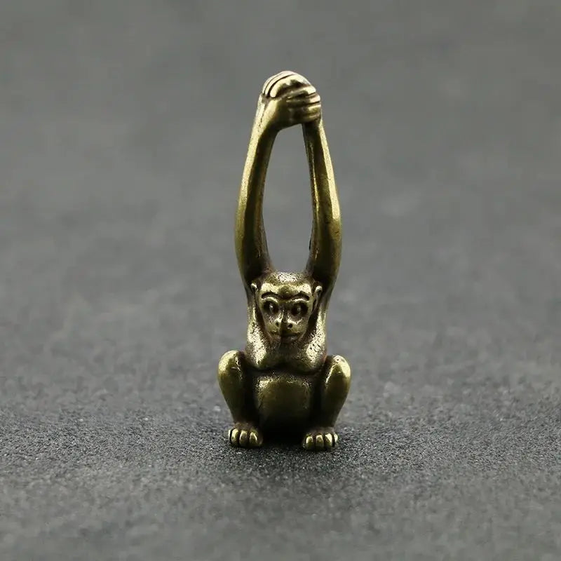 Vintage brass monkey key chain charm with a detailed, sculpted figure.