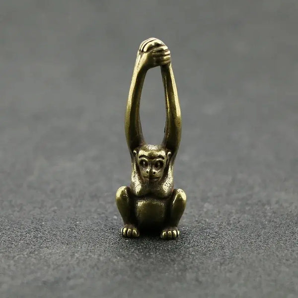 Vintage brass monkey key chain charm with a detailed, sculpted figure.
