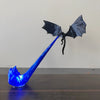 A blue dragon flame light fixture with a black bat-like wing design.