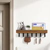 A rustic wooden floating shelf with hooks mounted on a white wall, displaying decorative figurines and cards.