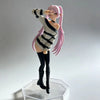 A figurine of an anime-style girl with pink hair wearing a striped sweater and black boots.