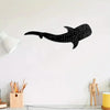 Black silhouette of a whale shark with white polka dots mounted on a white wall.