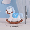 A white horse baby block topper featuring a light blue mane and bridle, mounted on a brown base.