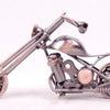 A handcrafted metal motorcycle model with chrome components and a vintage aesthetic.